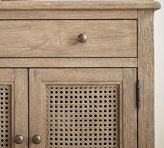 Wooden cabinet with a textured finish and metal knobs on a white background