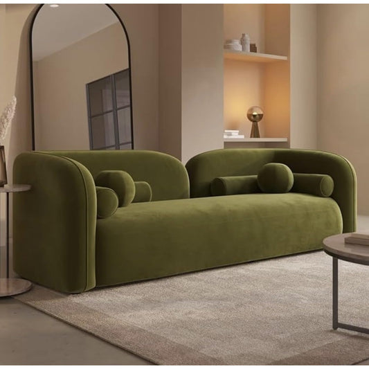 Green sofa in a modern living room with a large mirror and side table.