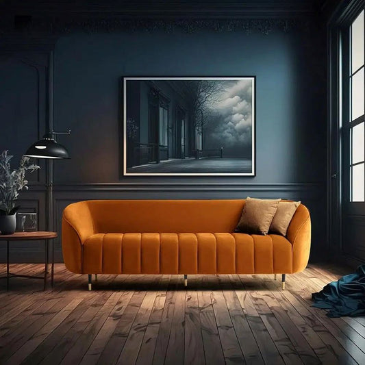 Orange sofa in a room with a dark blue wall and a large framed picture.