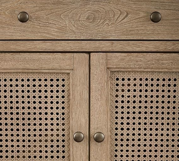 Close-up of wooden cabinet with rattan patterns and metallic knobs
