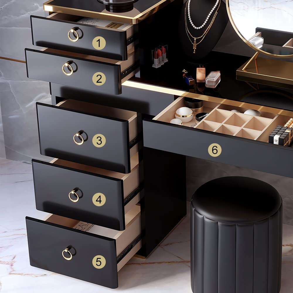 Black jewelry organizer with drawers and a stool on a light background