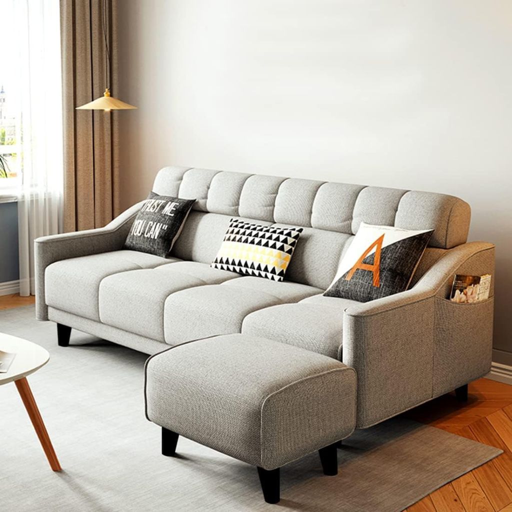Gray sectional sofa with decorative pillows in a living room setting.