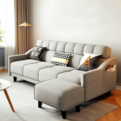 Gray sectional sofa with decorative pillows in a living room setting.