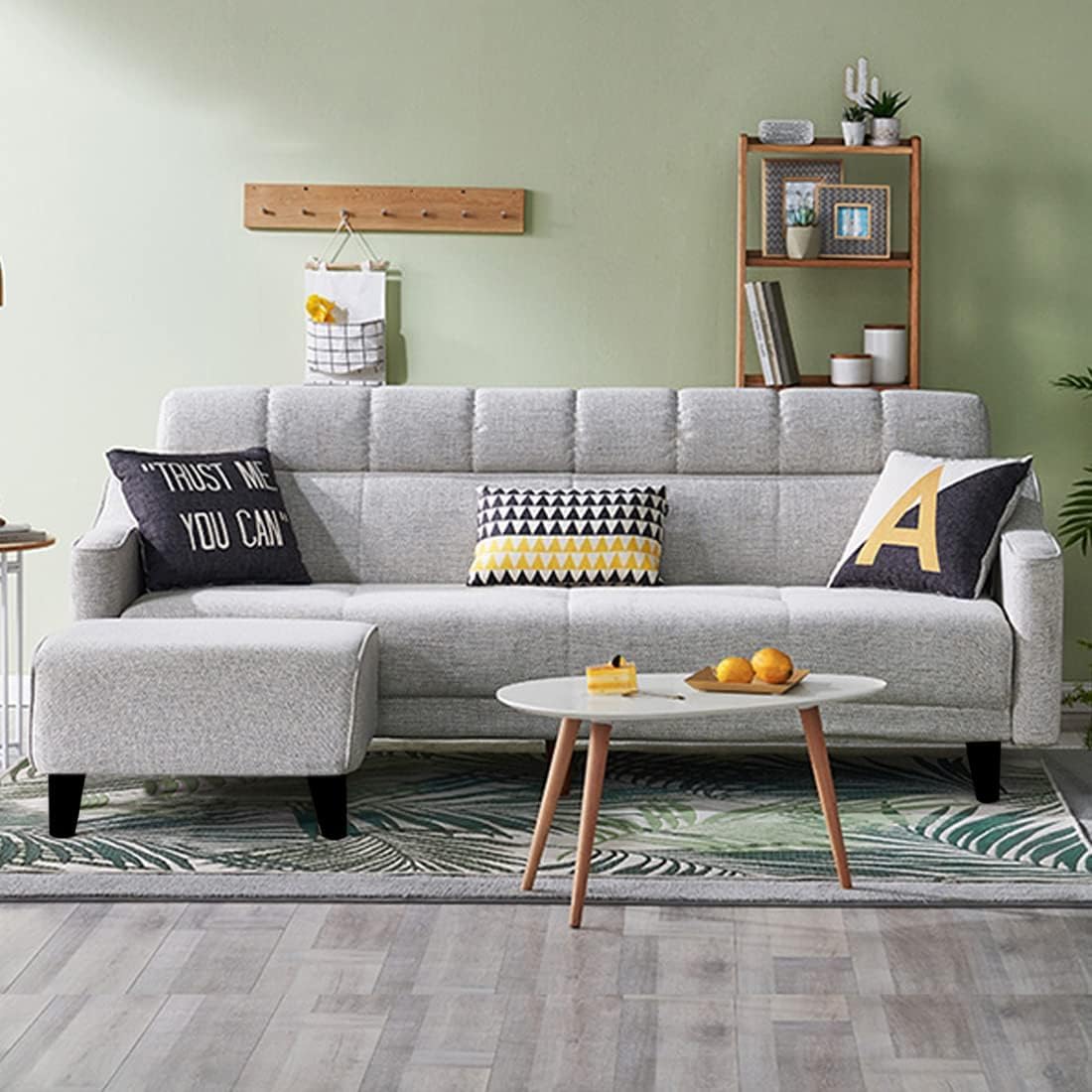 Gray sectional sofa with decorative pillows in a living room setting.