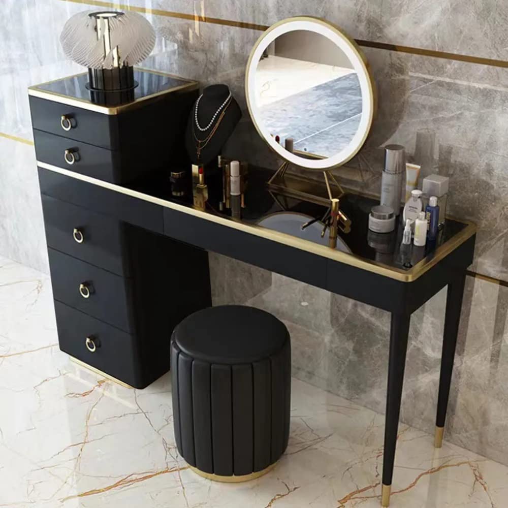 Black vanity table with mirror and makeup items in a bathroom setting