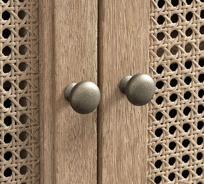 Wooden cabinet with decorative metal knobs on a wooden background