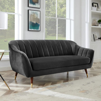 Gray sofa in a room with large windows and decorative elements.