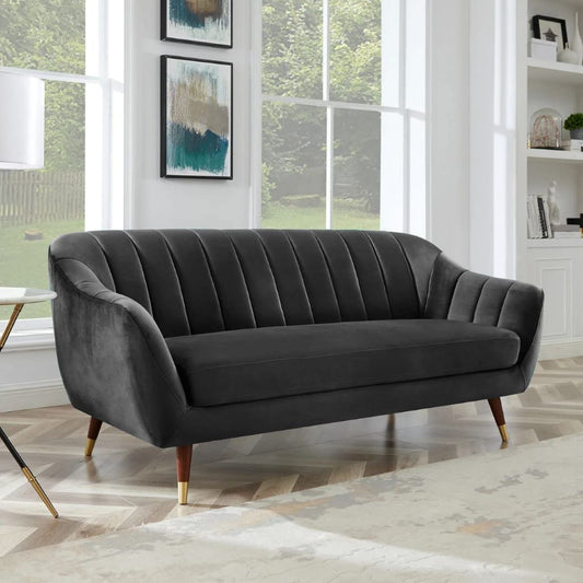 Gray sofa in a room with large windows and decorative elements.