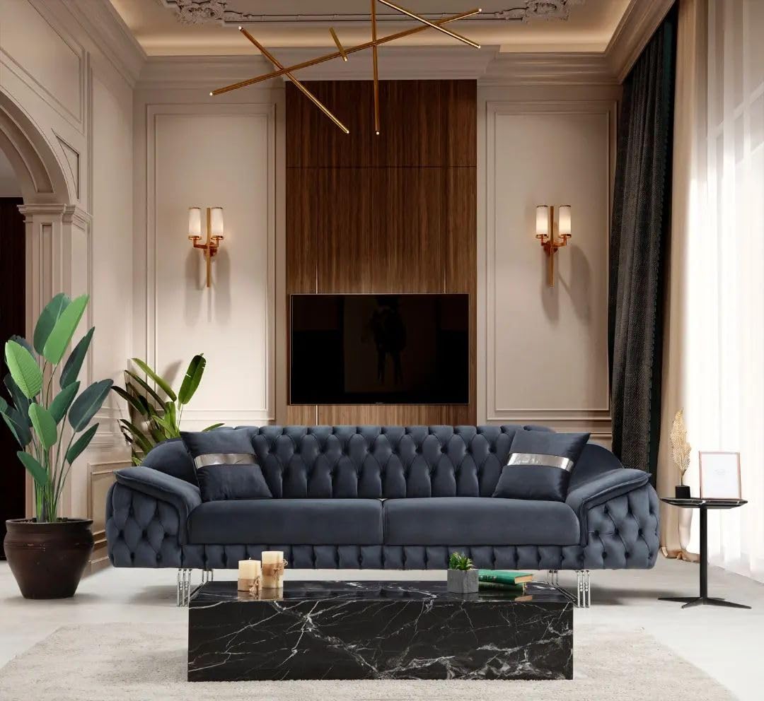 Modern living room with a blue sofa, marble coffee table, and decorative elements.