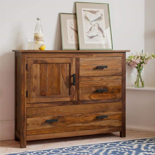 Wooden dresser with two doors and three drawers in a room setting.