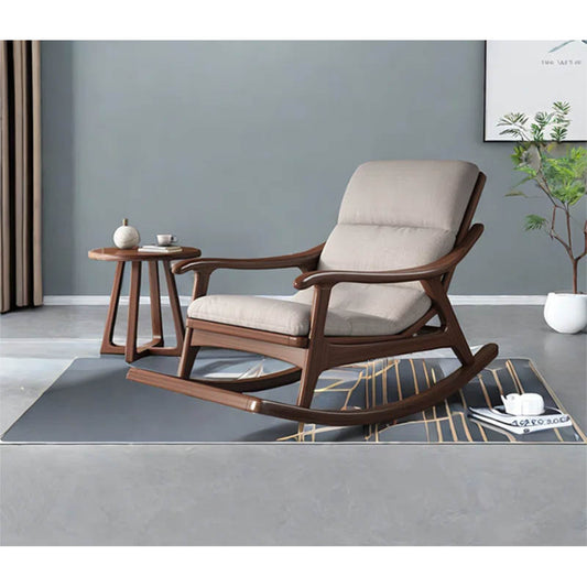 Wooden rocking chair with beige cushion in a room setting.