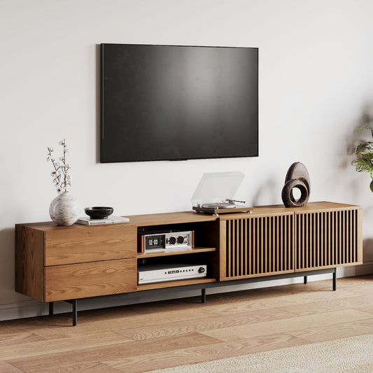 Wooden TV stand with a television mounted above it in a living room setting.