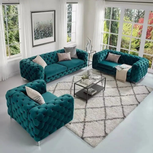 Modern living room with teal sofas and a glass coffee table.