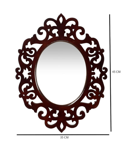 Decorative oval mirror with intricate brown frame on a white background