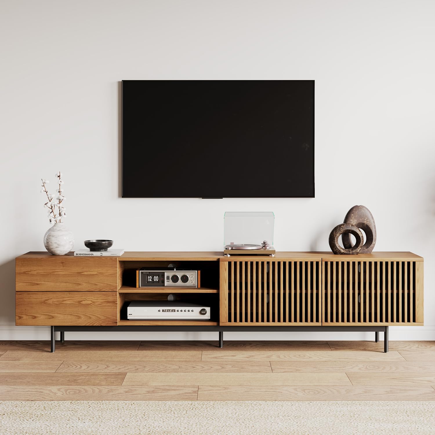 Wooden TV stand with a television mounted on the wall in a minimalistic room.