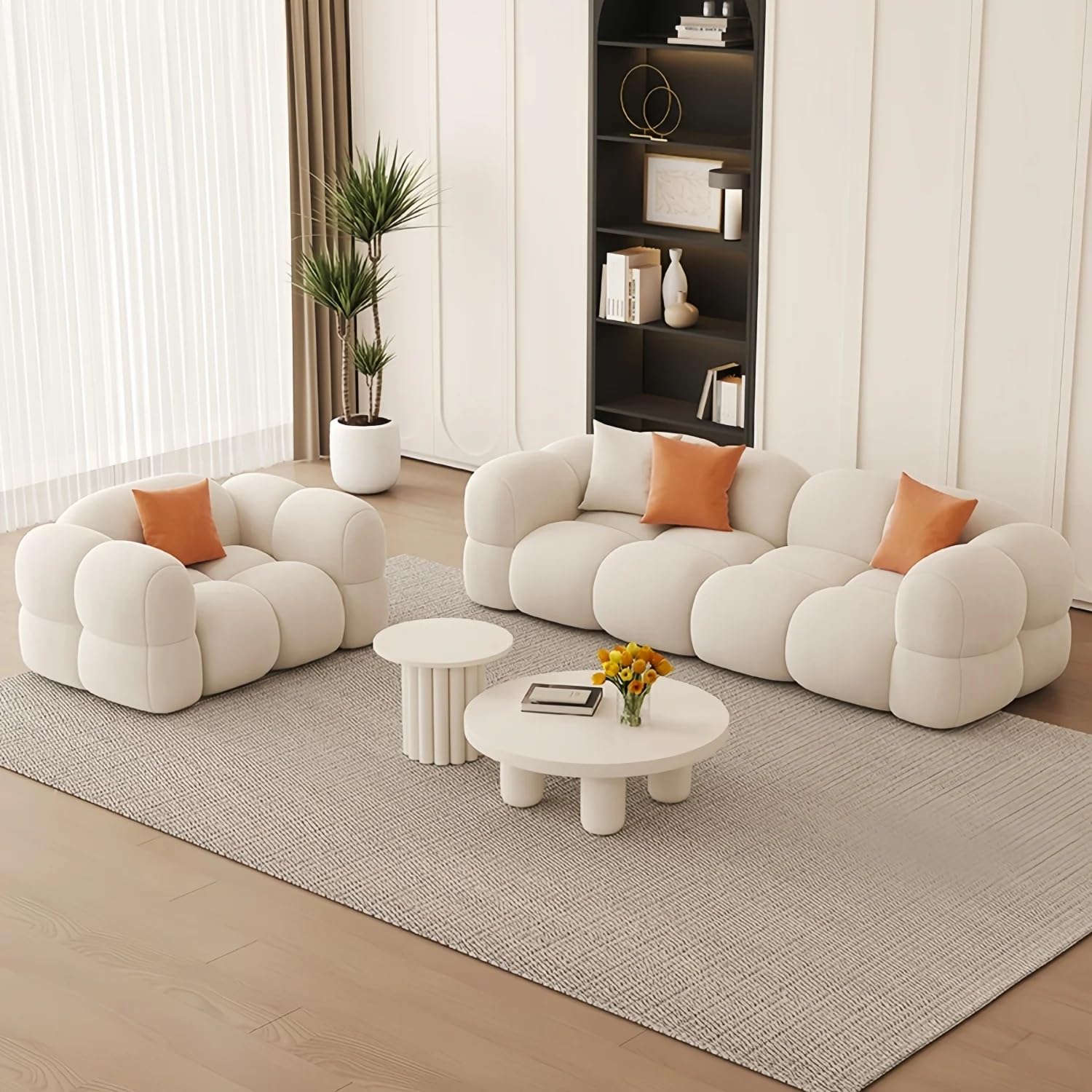 Modern living room with a white bubble-style sofa set, coffee table, and decorative elements.