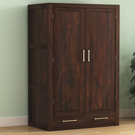 Wooden wardrobe with two doors and two drawers against a light green wall.