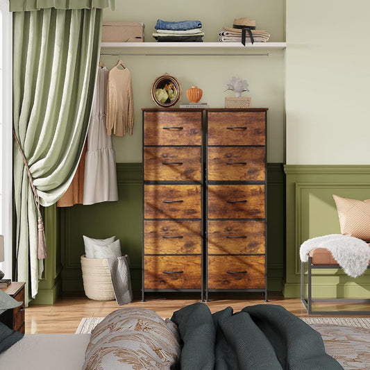 Wooden dresser in a bedroom with green walls and a bed in the foreground.