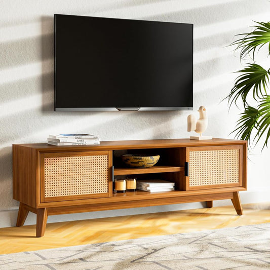 Wooden TV stand with a television mounted on a wall in a room with a plant.