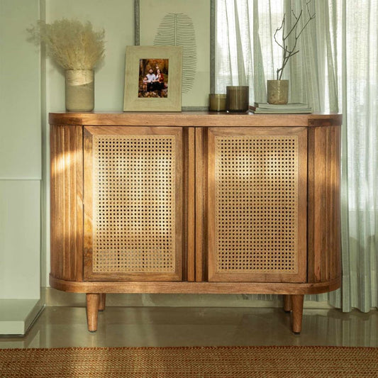 Wooden sideboard with wicker doors in a room setting