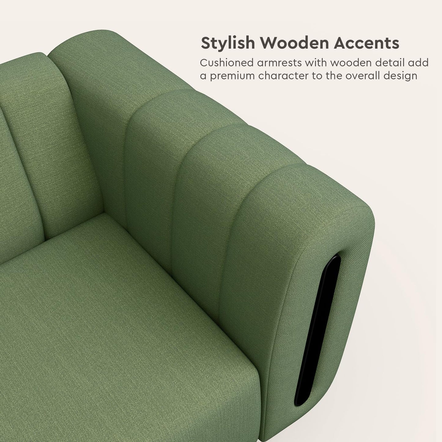 Green sofa with cushioned armrests and wooden accents on a light background