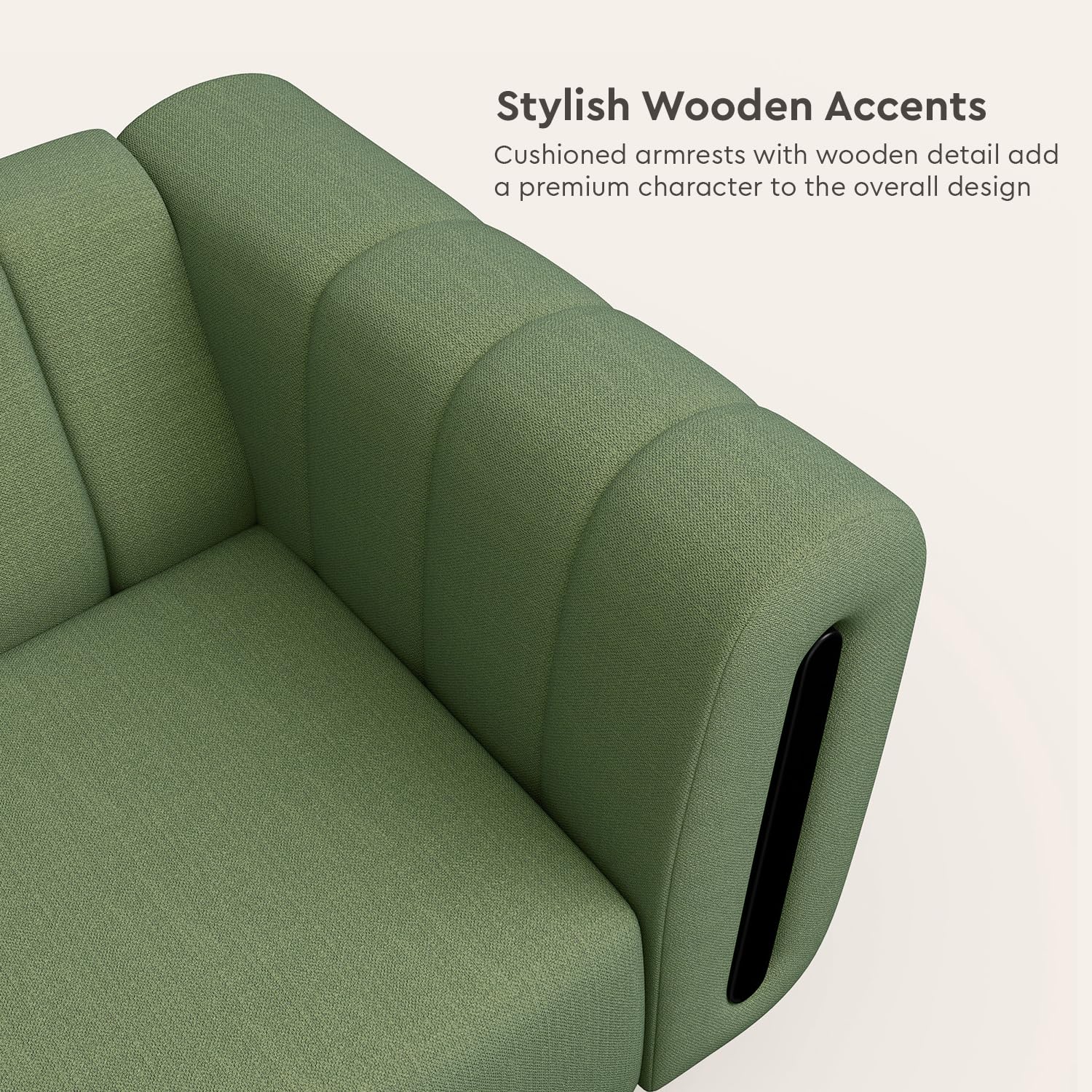 Green sofa with cushioned armrests and wooden accents on a light background