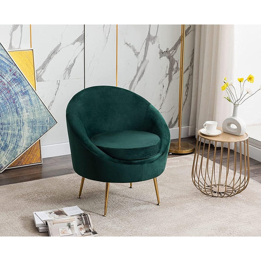 Green velvet armchair in a stylish living room with marble walls and a side table.