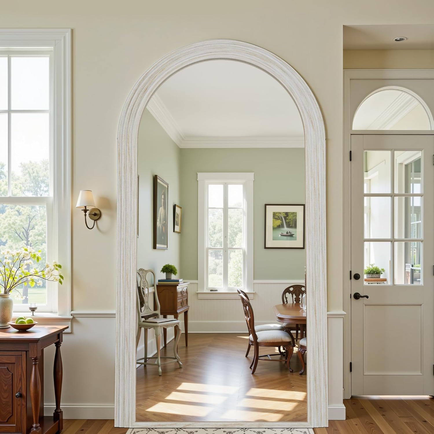 Archway leading to a dining room with wooden furniture and a lamp.
