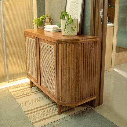 Wooden sideboard with wicker doors in a room setting