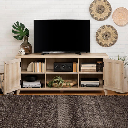 Wooden entertainment console with a TV and decorative items against a white brick wall.