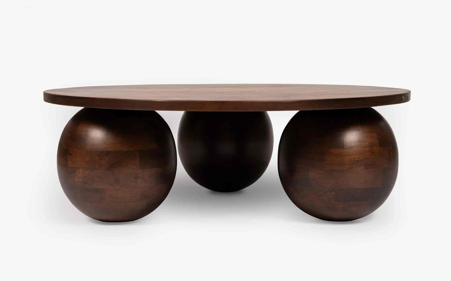 Wooden table with spherical bases on a white background