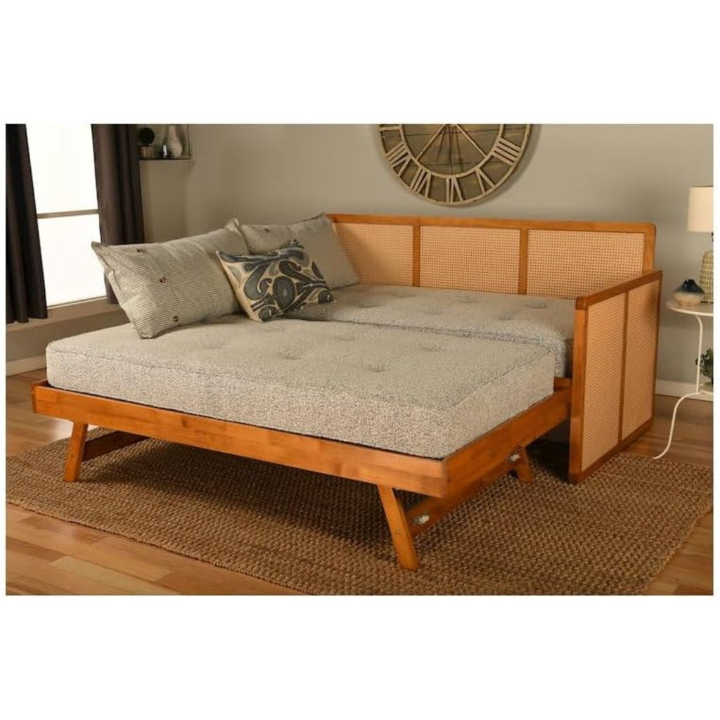 Wooden daybed with gray cushion in a room setting