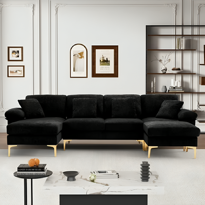 Black sectional sofa in a modern living room with decor elements.