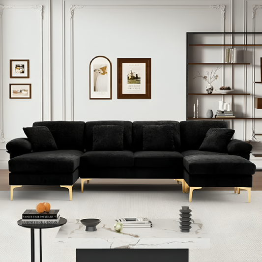 Black sectional sofa in a modern living room with decor elements.