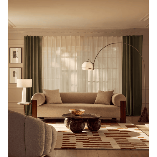Modern living room with beige sofa, coffee table, and decorative elements.