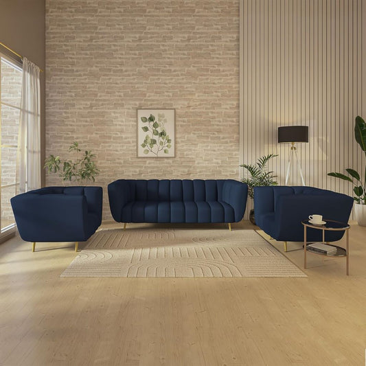 Modern living room with navy blue sofa and chairs against a brick wall.
