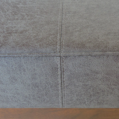 Close-up of gray tiles with a wooden floor at the bottom