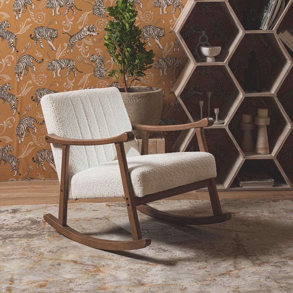 Rocking chair in a room with tiger-patterned wallpaper and hexagonal wall shelf.