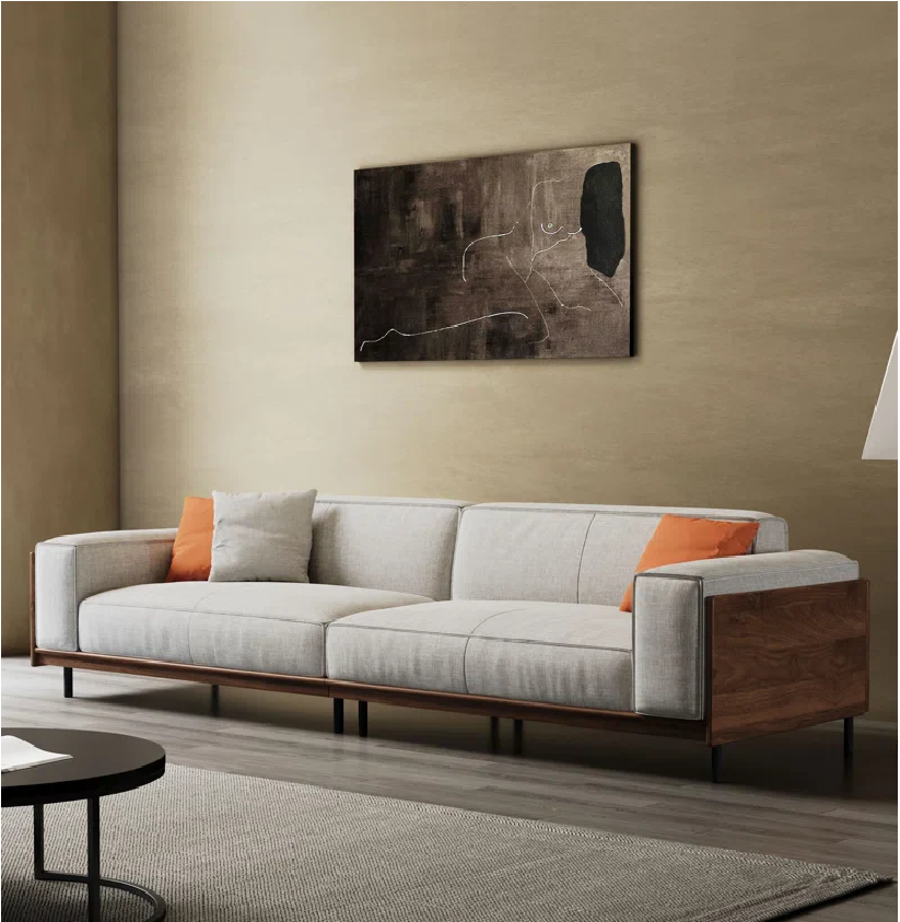 Modern living room with a gray sofa, wooden frame, and abstract painting on the wall.
