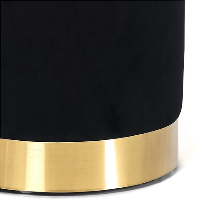 Black cylindrical object with a gold base on a white background