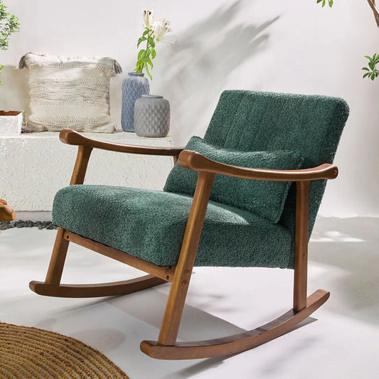 Green upholstered rocking chair with wooden frame on a white floor.