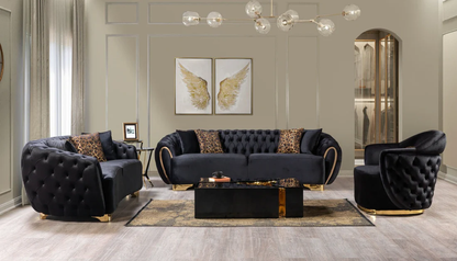 Modern living room with black tufted sofa set and decorative elements.