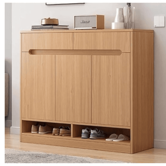 Wooden shoe cabinet with open doors showing shoes inside, placed against a white wall.