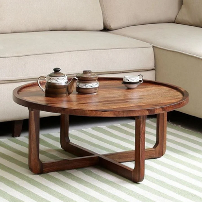 Wooden coffee table with tea set in a living room setting