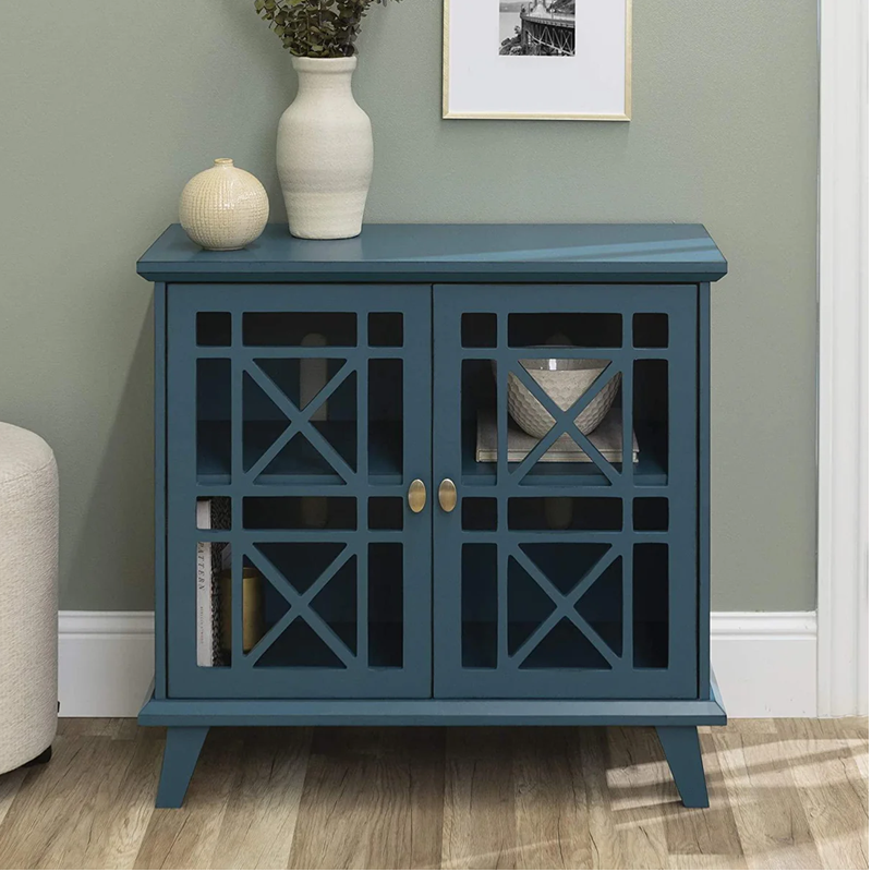 Blue cabinet with decorative items on a gray wall