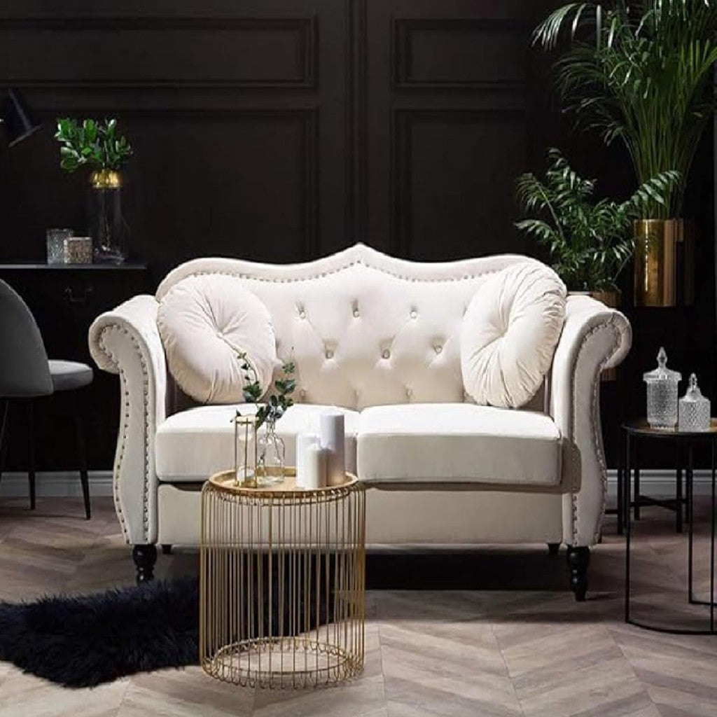 White tufted sofa in a stylish living room with decorative elements.