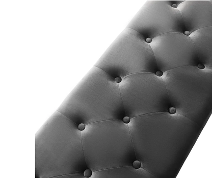 Gray tufted headboard with button details on a white background