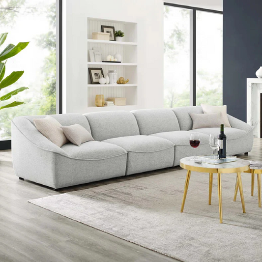 Gray sectional sofa in a modern living room with a coffee table and decor items.