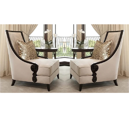 Two ornate chairs with decorative cushions in a room with curtains and a table.