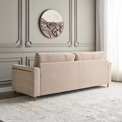 Beige sofa in a room with decorative wall molding and a circular artwork.